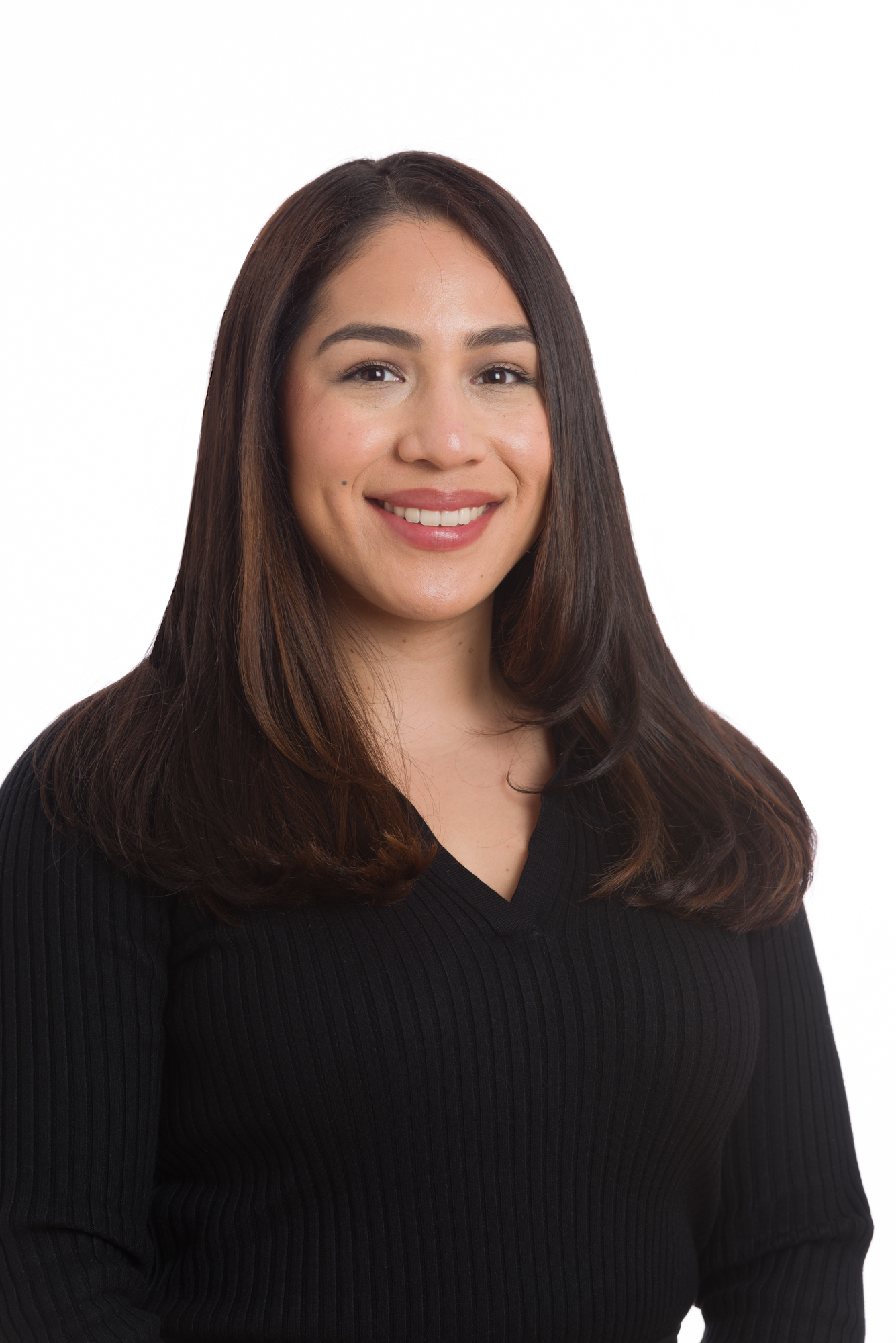 Smiling woman with long brown hair, wearing a black sweater, against a plain white background.